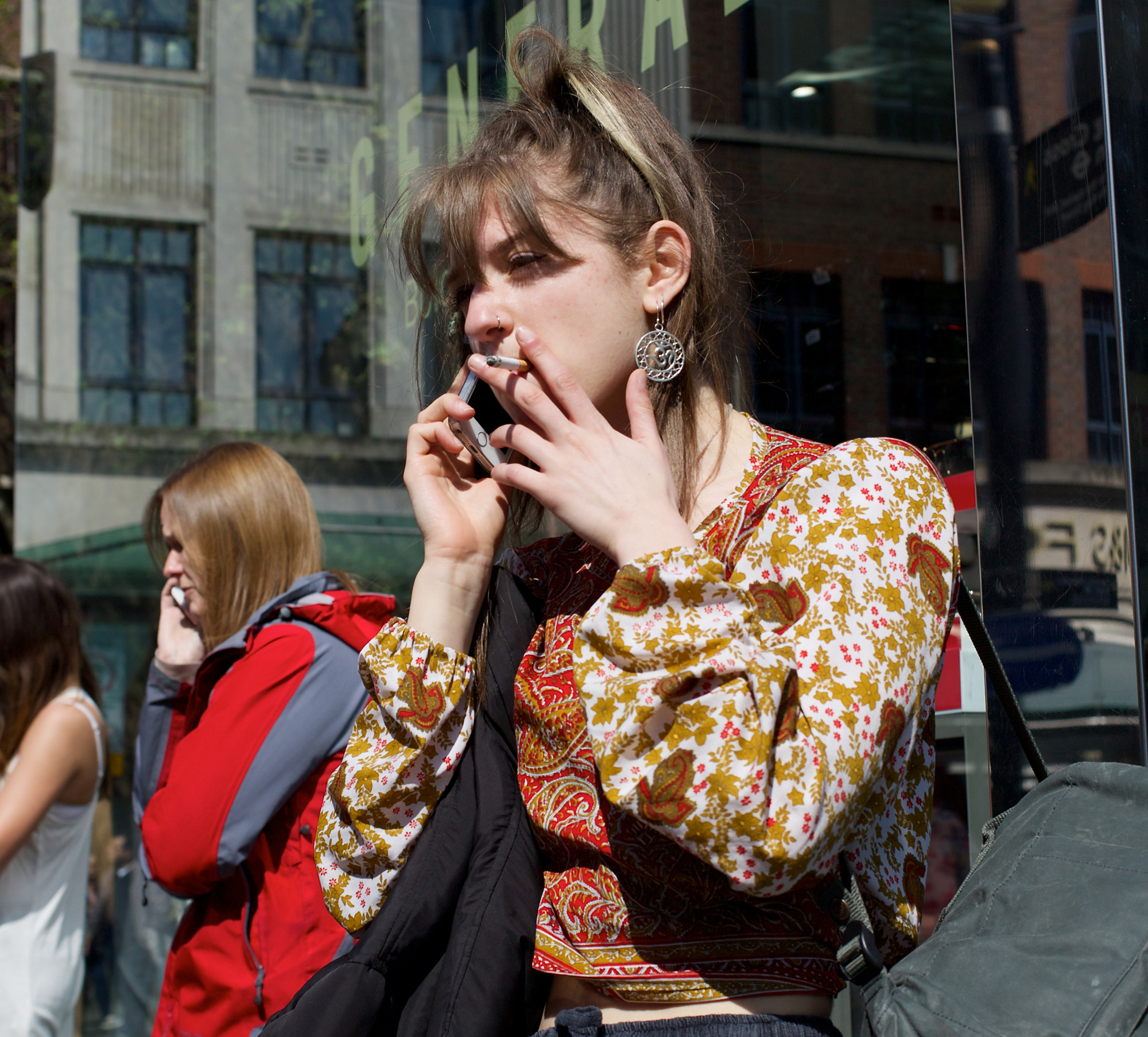 Woman smoking cigarette, chatting on phone