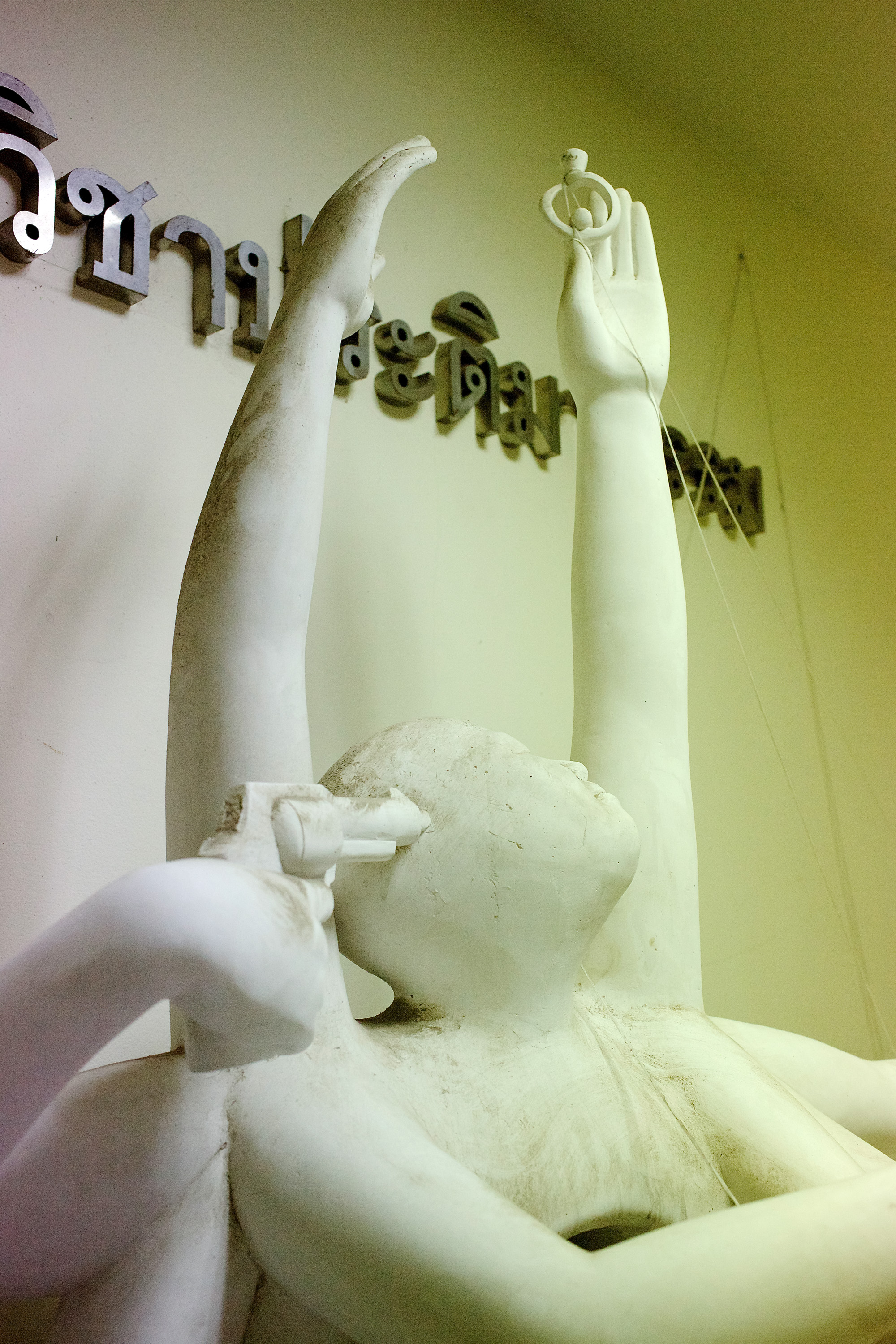 Sculpture with raised hands